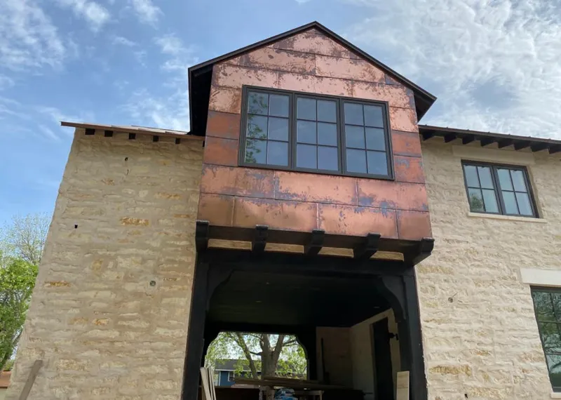 Copper metal panel facade on a stone building for Metal Roof Coating in Hillside